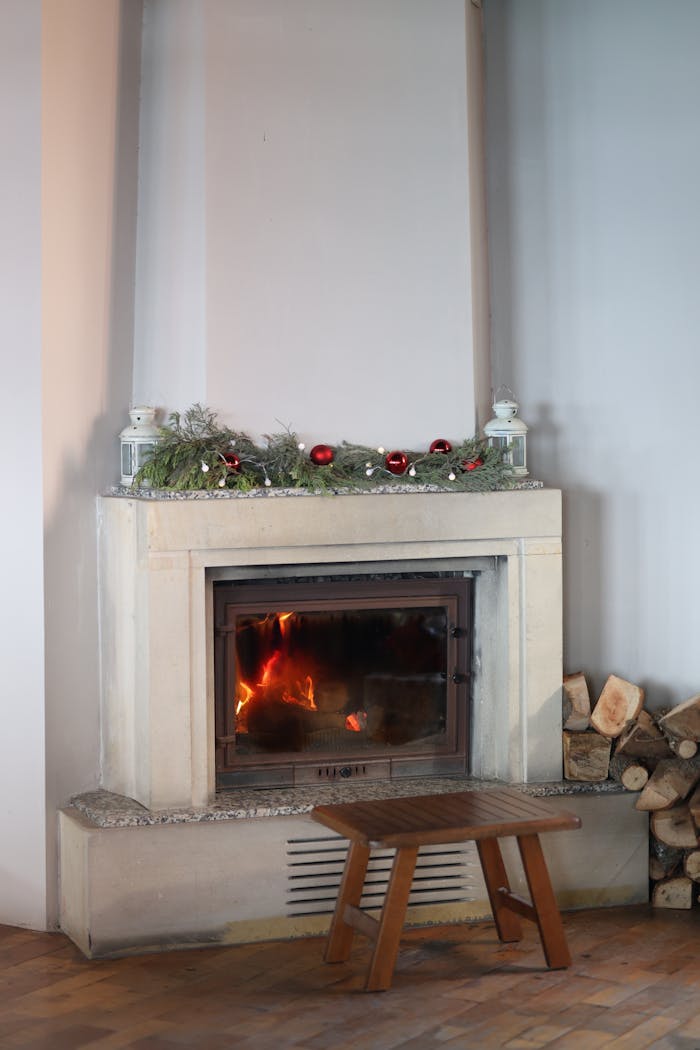 About Warm indoor fireplace decorated for the holidays, creating a festive atmosphere.